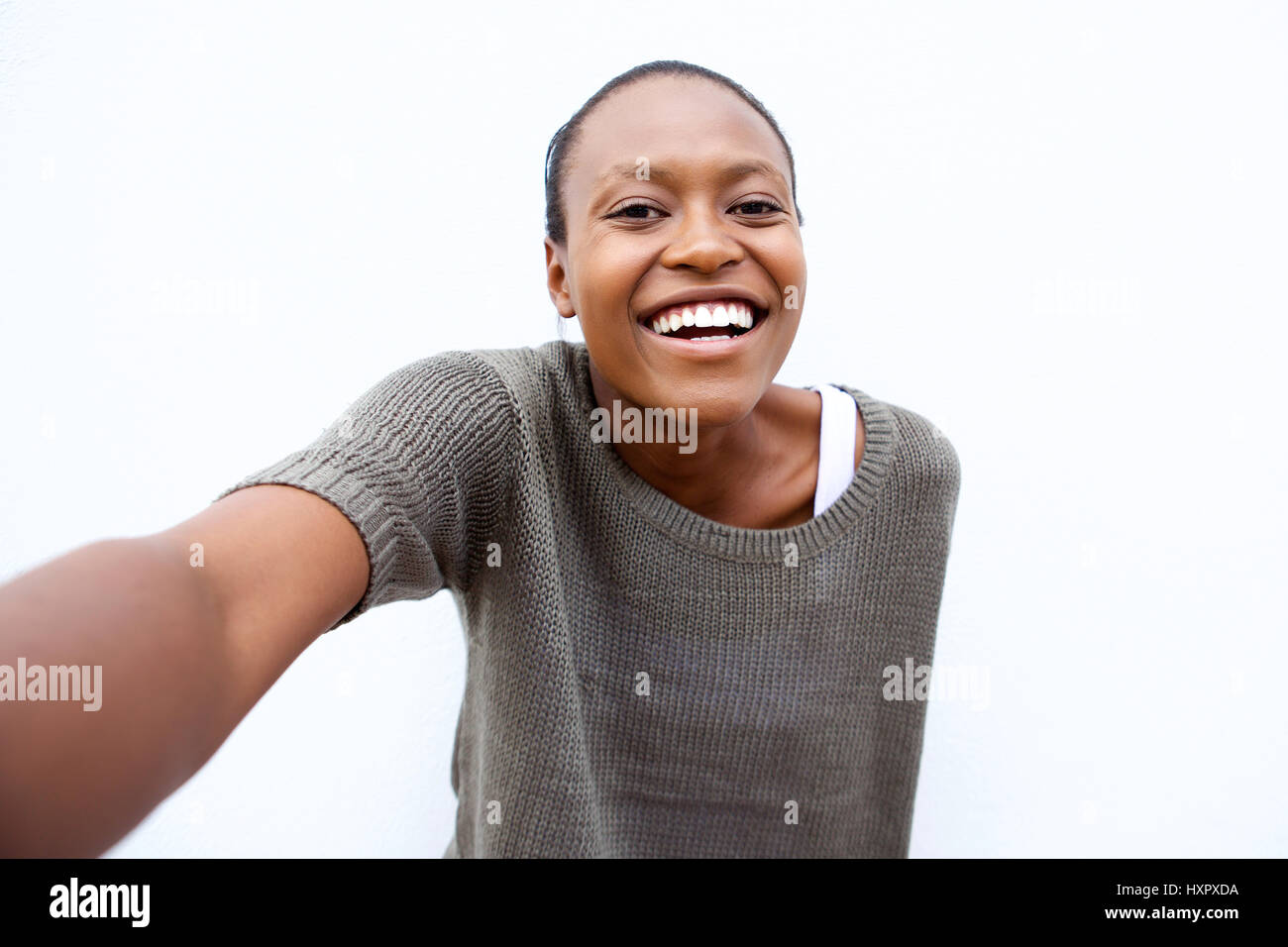 Selfie portrait of smiling young african american woman against white ...