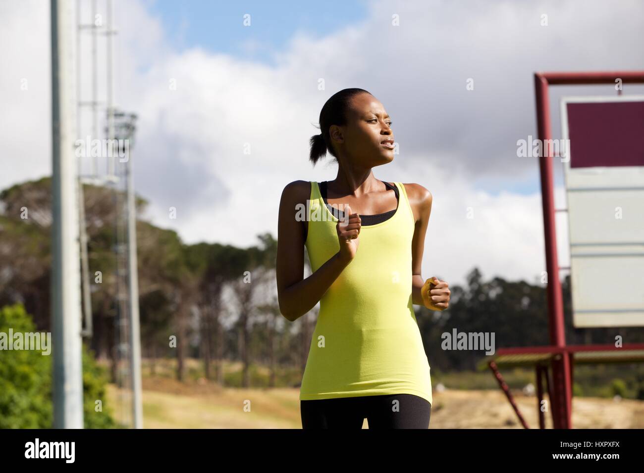 Portrait of a fit young woman running outside Stock Photo