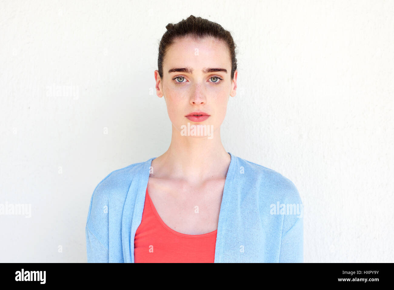 Close up portrait of young healthy woman against white wall Stock Photo ...