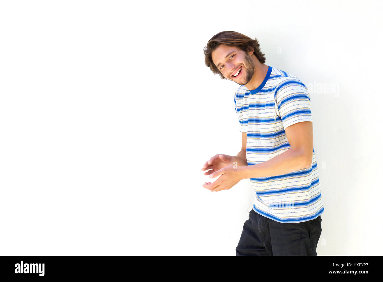 Portrait of smiling young man against white background Stock Photo - Alamy