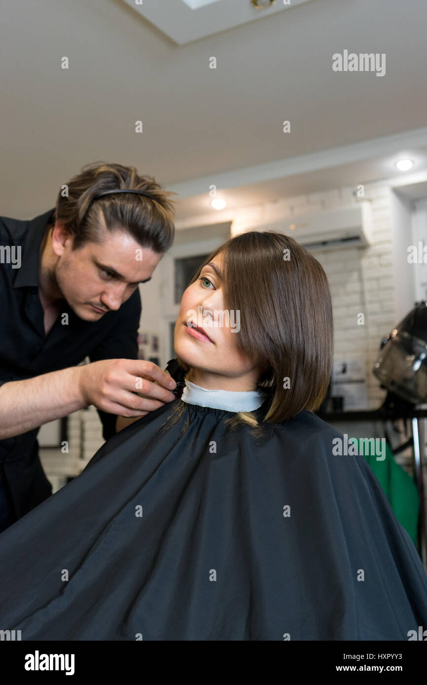 Male Hairdresser Does A Haircut To Pretty Woman In The Beauty