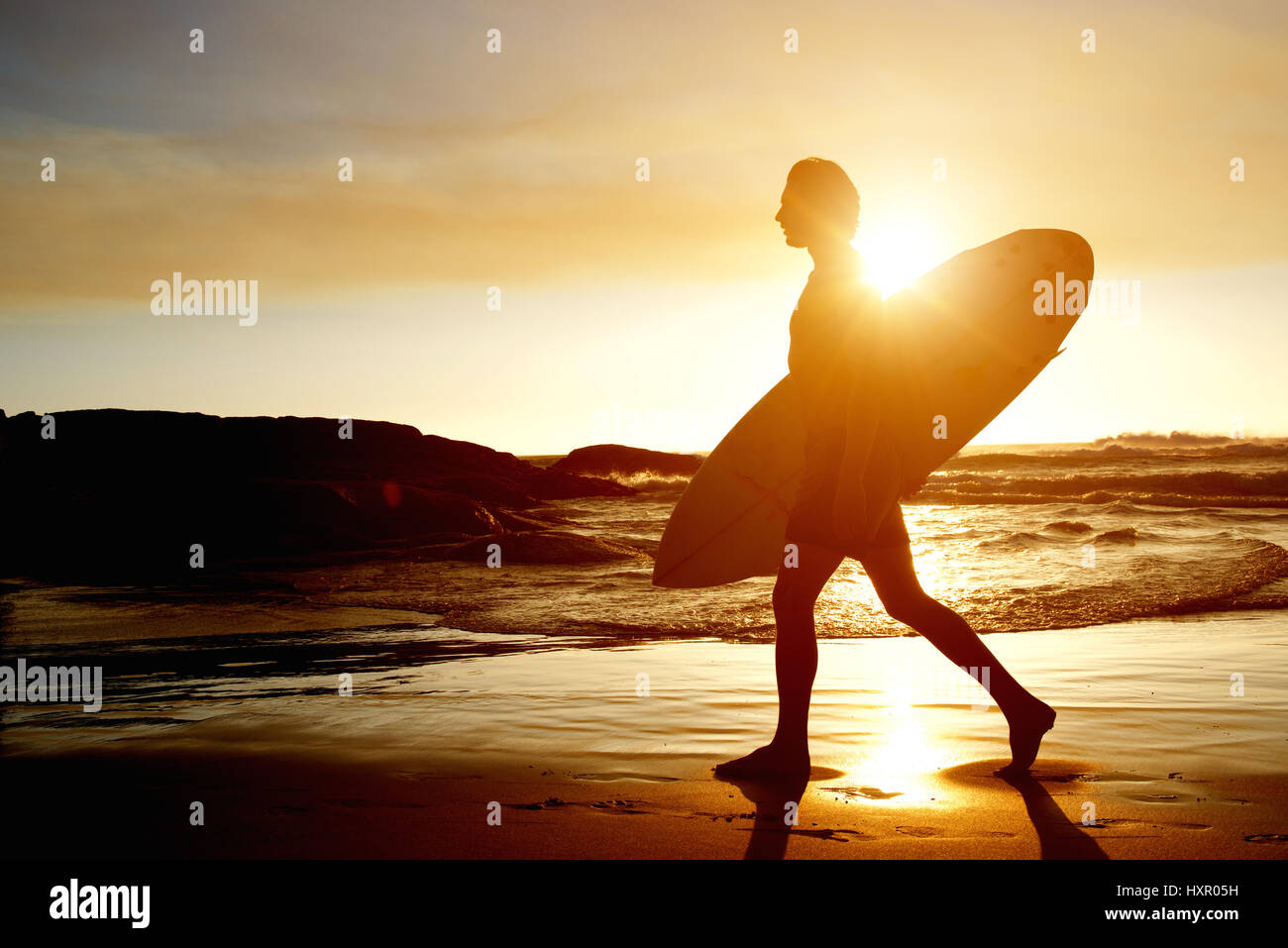 Silhouette surfer holding surfboard on hi-res stock photography and ...