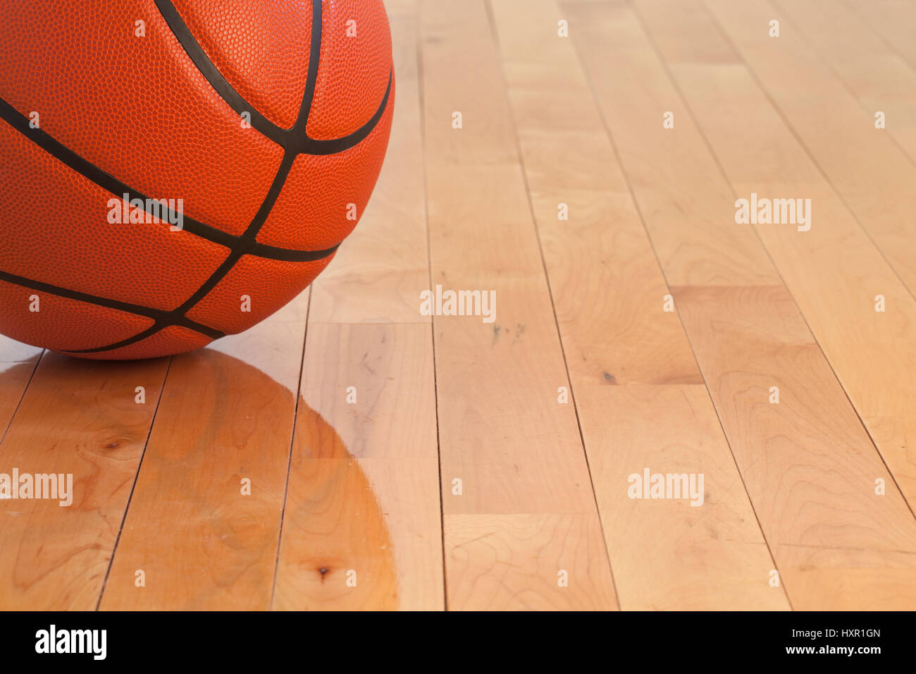 Low angle view of a basketball on a wooden gymnasium floor Stock Photo