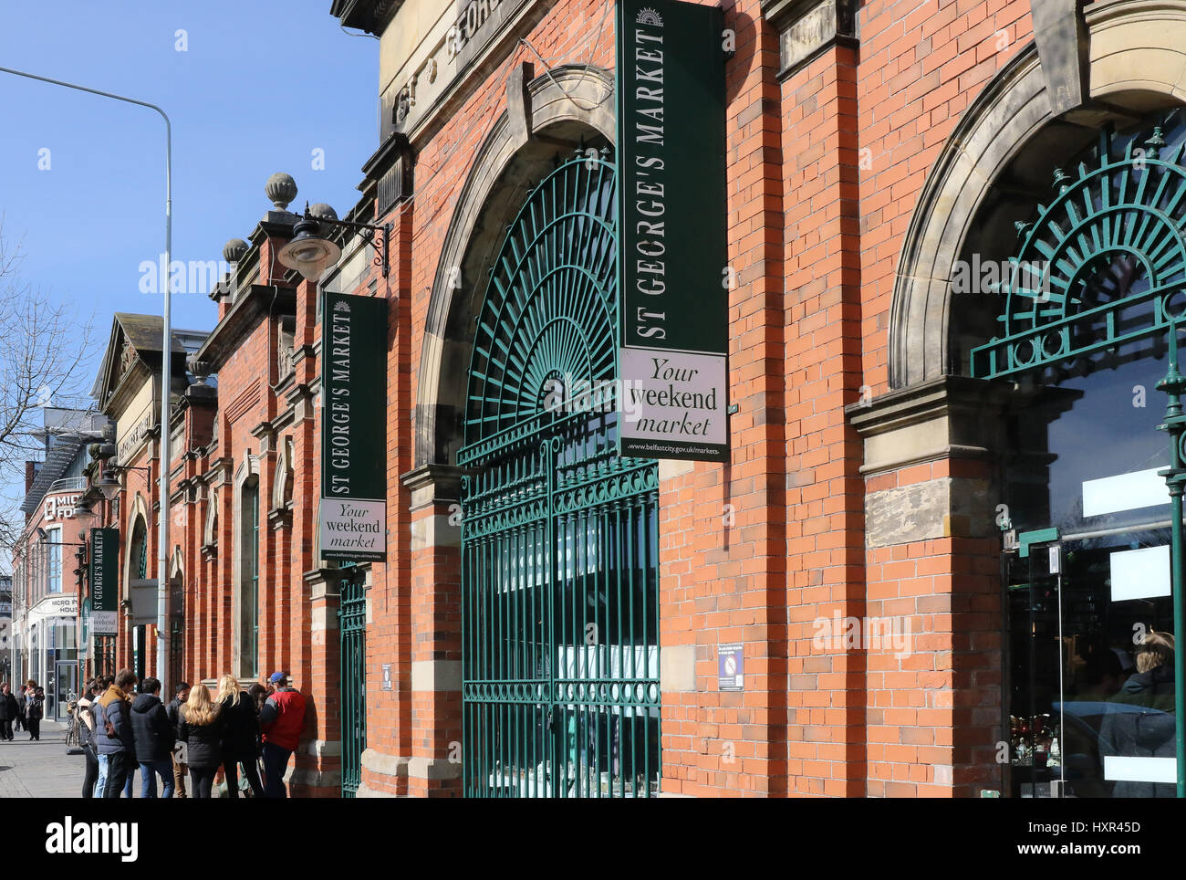 Gates , wall and the outside of St George's Market Belfast Northern Ireland on a sunny day with blue sky.. Stock Photo