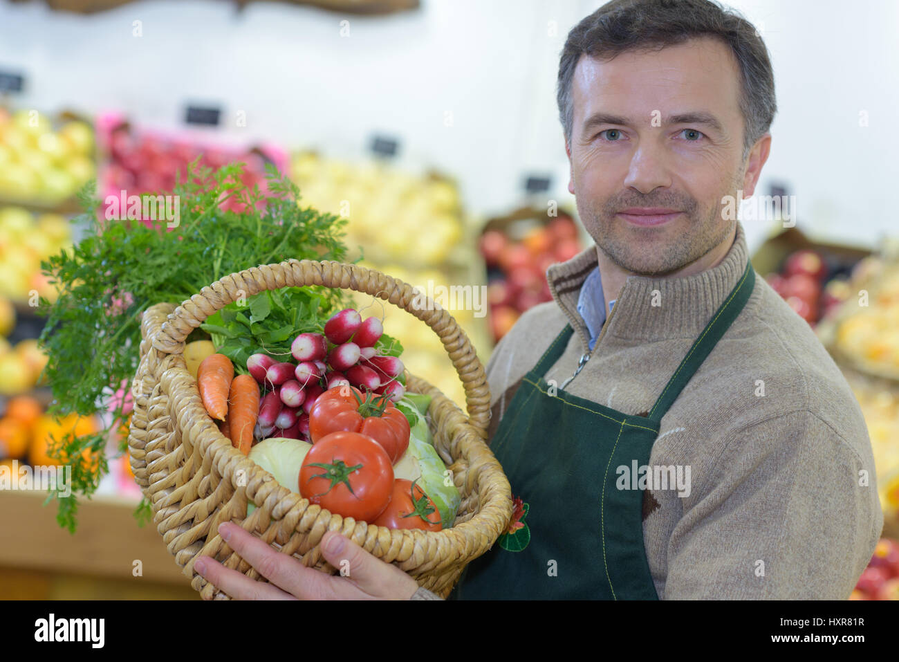 young grocery clerk posing in produce aisle of grocery store Stock Photo Alamy