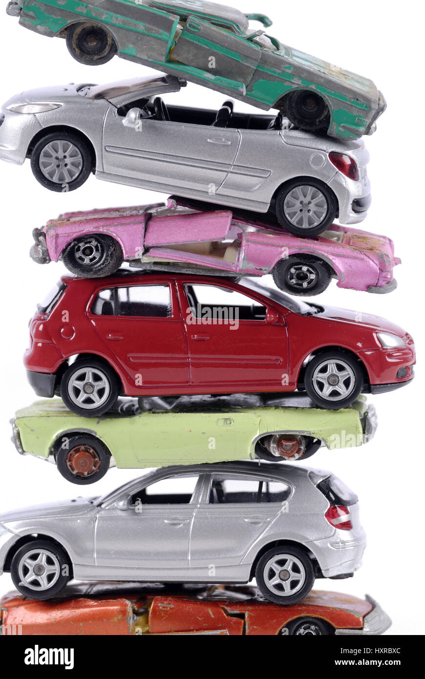 Broken and new stacked miniature cars, stagnant new carriage sales at the end of the cash for clunkers, Kaputte und neue gestapelte Miniaturautos, sto Stock Photo