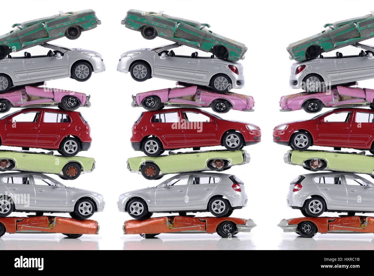 Broken and new stacked miniature cars, stagnant new carriage sales at the end of the cash for clunkers, Kaputte und neue gestapelte Miniaturautos, sto Stock Photo