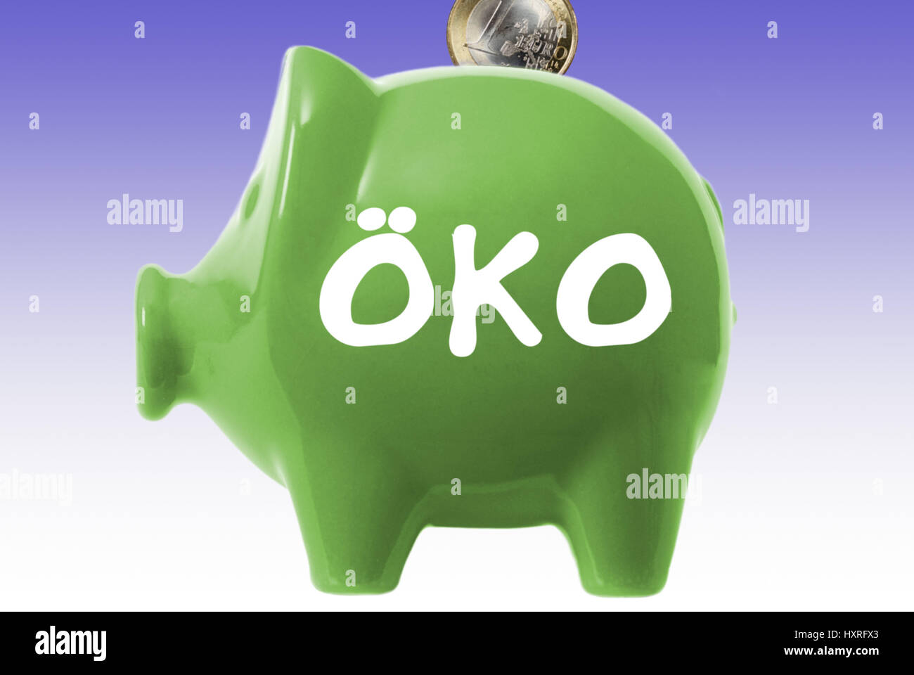 Green piggy bank with ecological label, Grünes Sparschwein mit Öko-Aufschrift Stock Photo