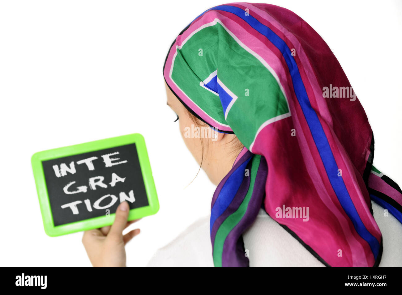 'Young woman with headscarf and board with the stroke ''integration''', Junge Frau mit Kopftuch und Tafel mit dem Schriftzug 'Integration' Stock Photo