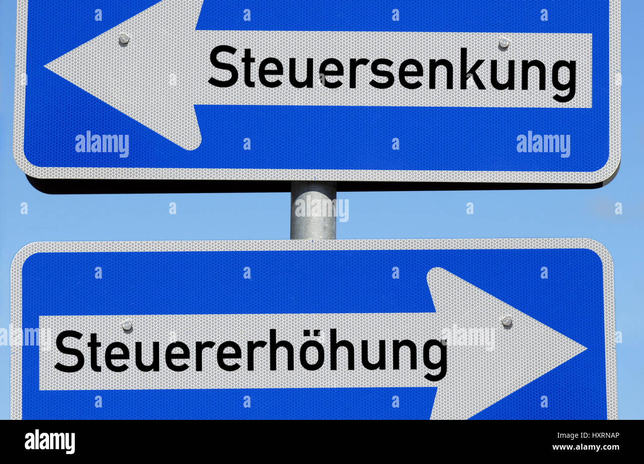 One-way street signs Tax lowering and Tax rise, Einbahnstraßenschilder Steuersenkung und Steuererhöhung Stock Photo