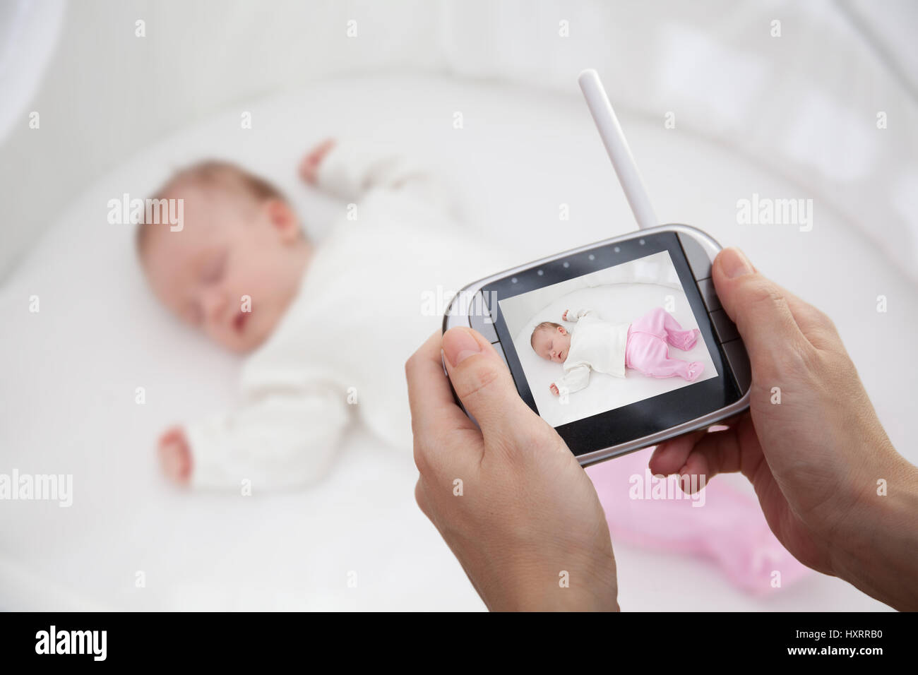 Hand holding video baby monitor for security of the baby Stock Photo