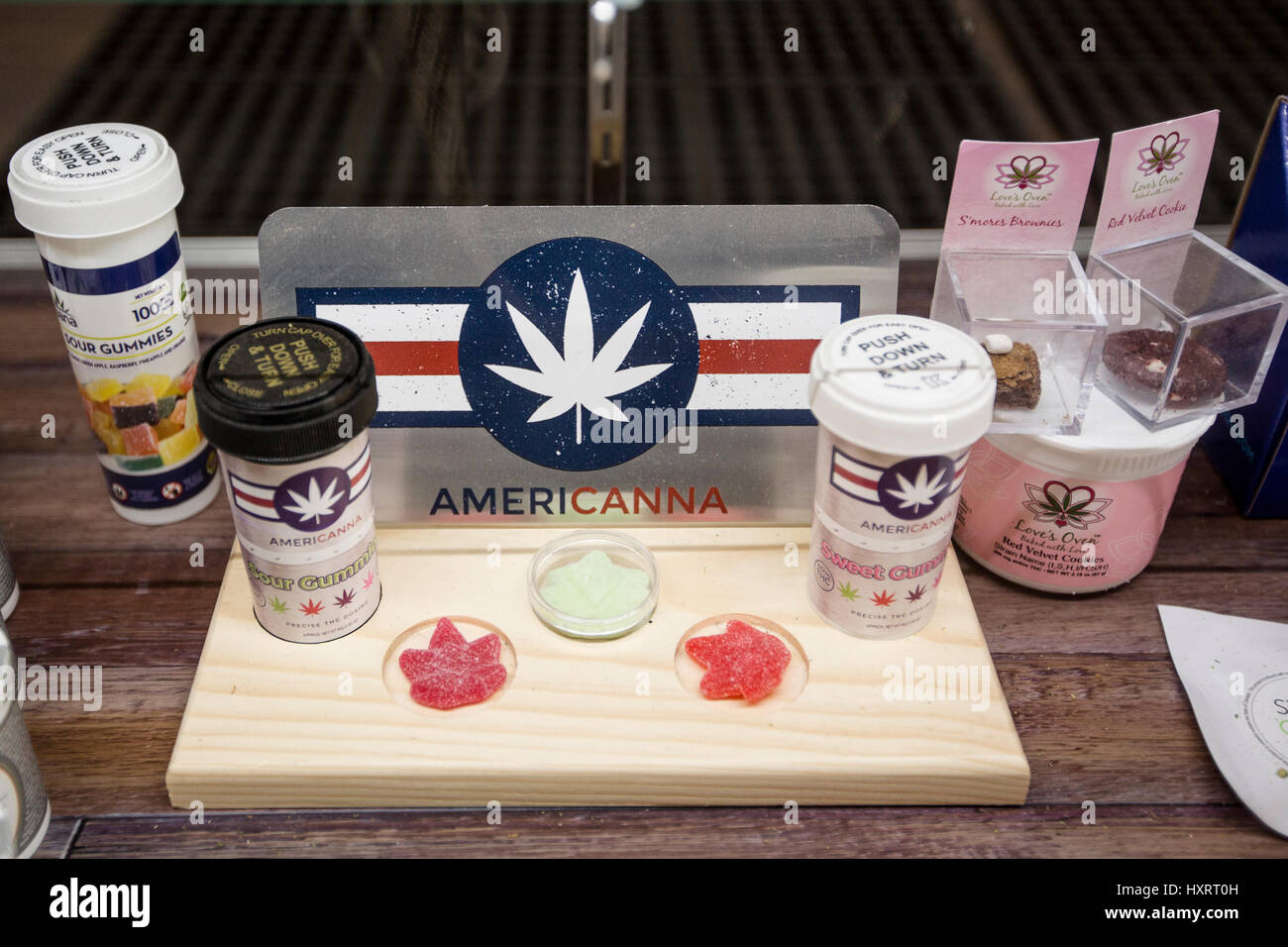 A selection of cannabis edibles on the shelf of a display case in a dispensary Stock Photo