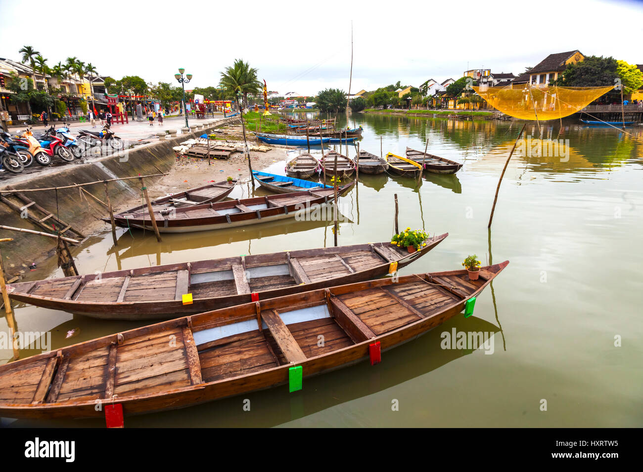 Boats line the canal in Hoi An in Vietnam Stock Photo