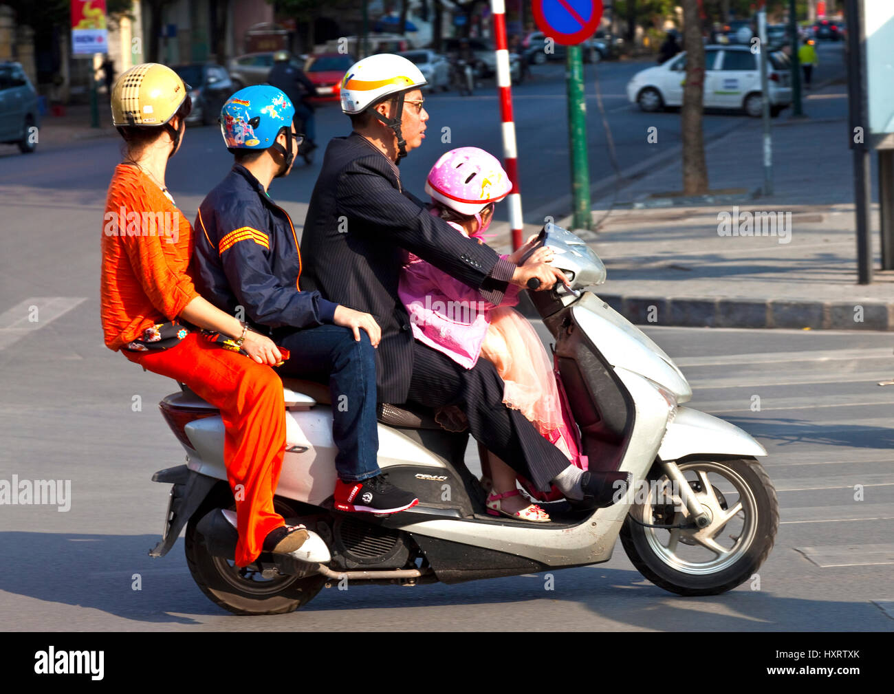 Family of four on scooter in Hanoi Stock Photo