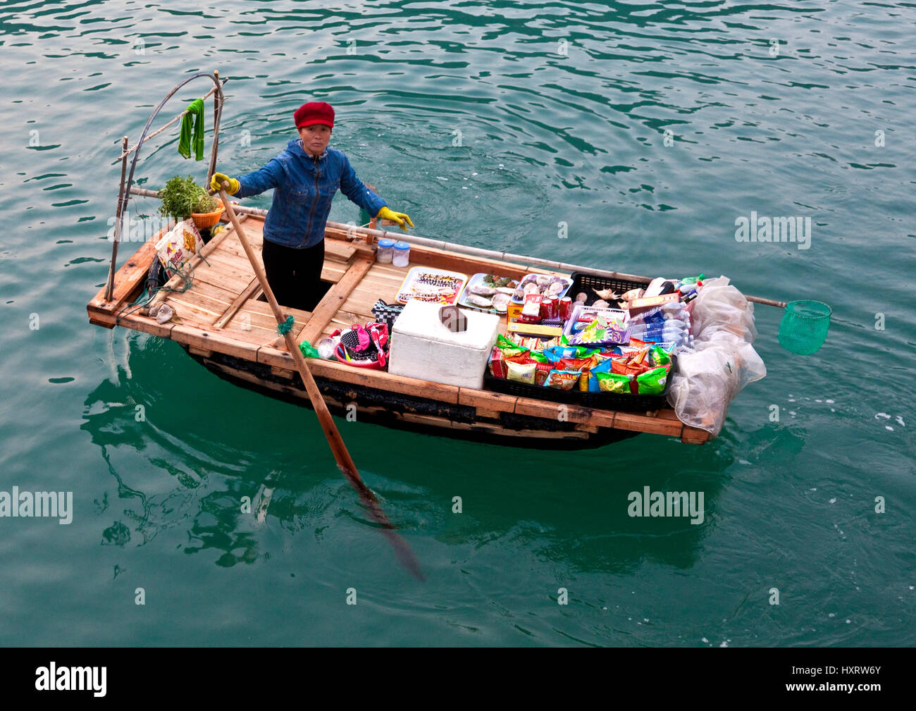 Vietnamese woman offers goods for sale on Ha Long Bay Stock Photo