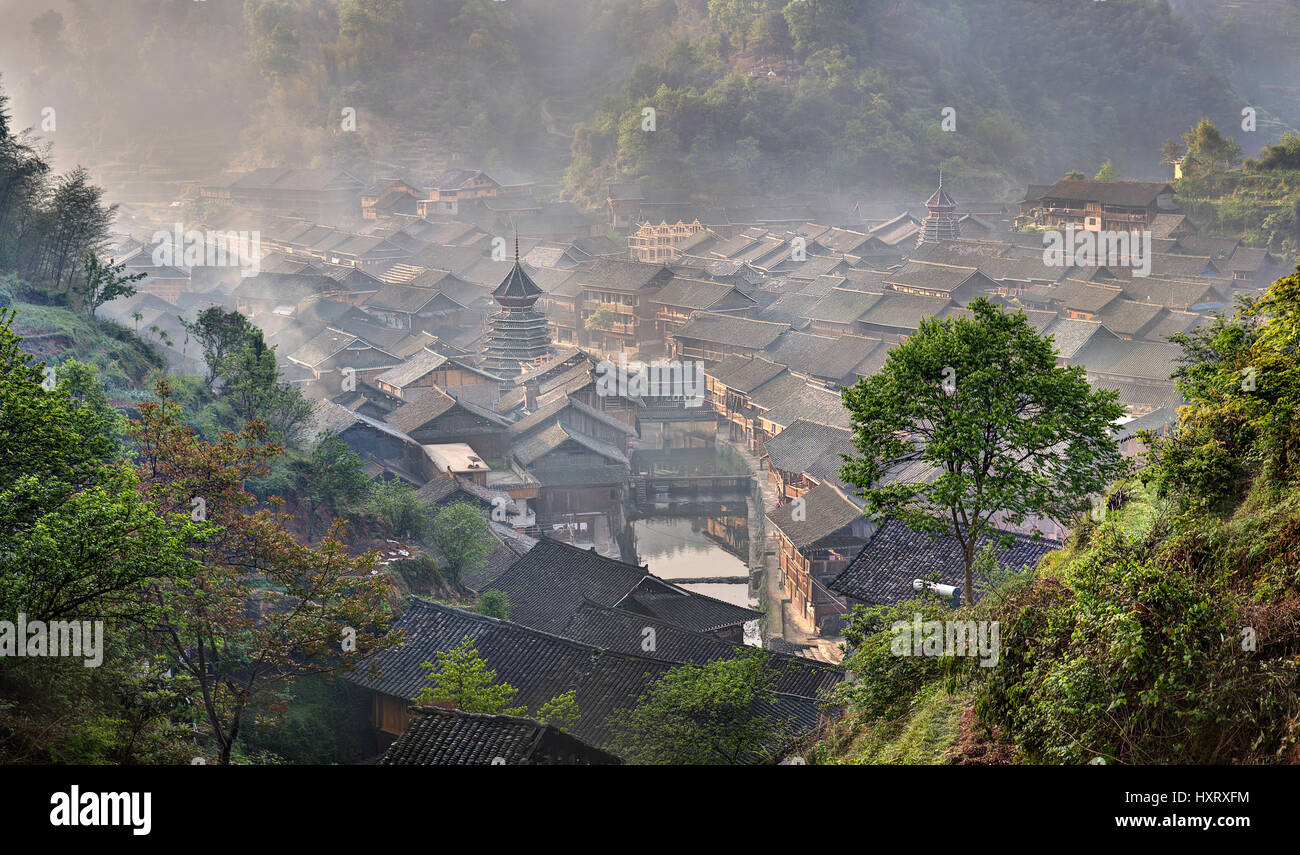 Zhaoxing Dong Village, Guizhou Province, China -  April 9, 2010: Ancient mountain village of Dong ethnic minority in southwest China, the morning mist Stock Photo