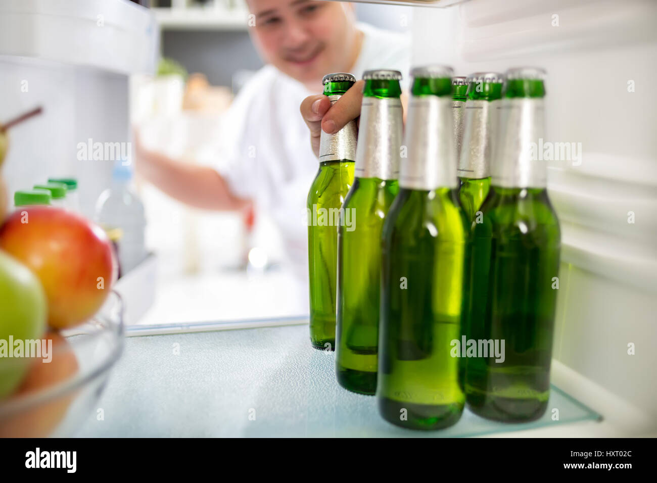 Boy take bottle of cold beer from refrigerator Stock Photo Alamy
