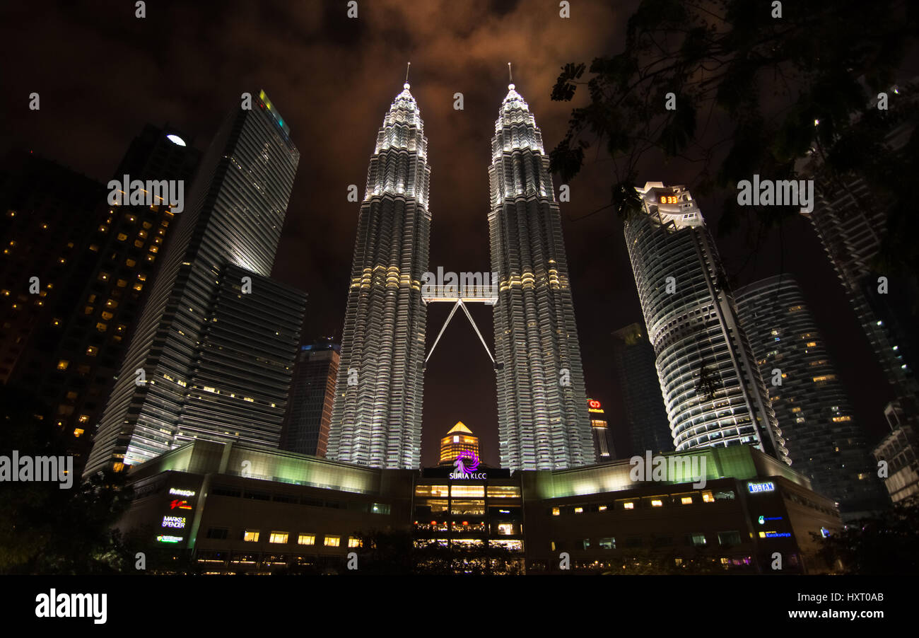 Petronas Twin towers and surrounding building of Kuala Lumpur, Malaysia at night from a low angle. Stock Photo