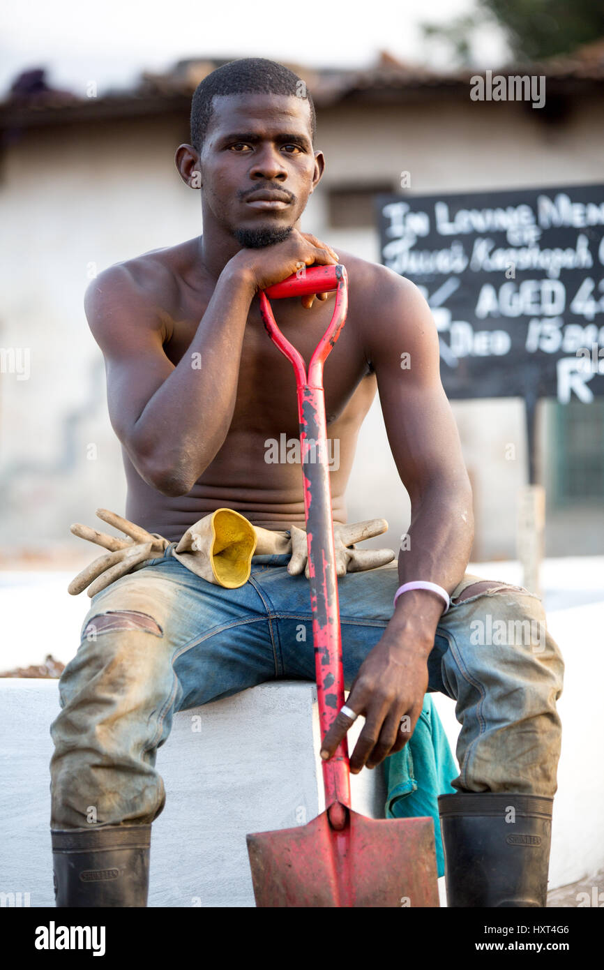 Portrait of a grave digger in Freetown. Only safe burial practice is
