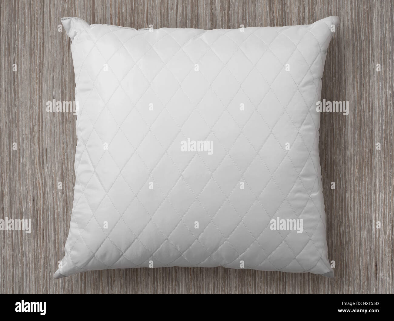 white pillow on wooden floor Stock Photo