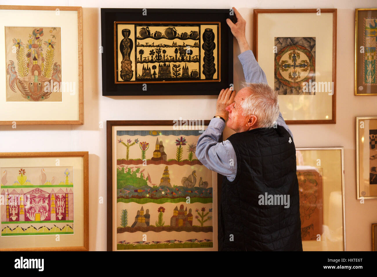 Oxford, UK. 29th Mar, 2017. Antique dealers setting up for The Cotswolds Art and Antiques Dealers' Association (CADA) Fair, which runs over the weekend, 30th March - 2nd April at Blenheim Palace, Woodstock, Oxfordshire, UK. John Howard with his rare collection of Scotty Wilson paintings.(This one was owned by lowrie). Picture by Richard Cave 29.03.17 Credit: Richard Cave/Alamy Live News Stock Photo