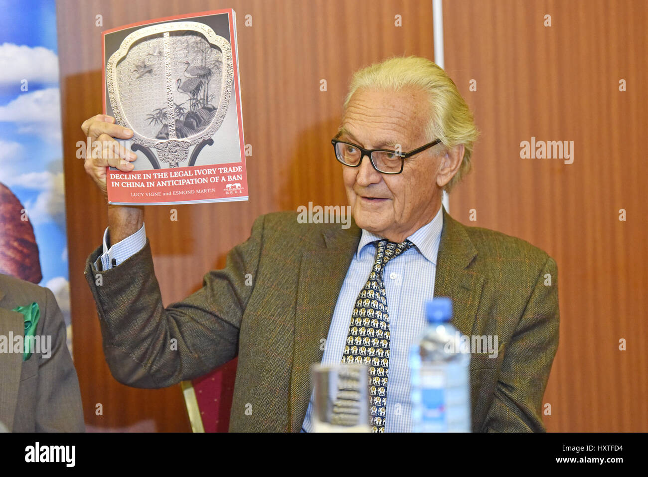 (170331)--NAIROBI, March 31, 2017(Xinhua)-- Iain Douglas Hamilton, Founder of Save the Elephants, a conservation organization, displays a report on China's legal ivory trade in Nairobi, Kenya, March 29, 2017. The historic ban on processing and sale of ivory products announced by China on December 31, 2016 could herald demise of elephant poaching in Africa, says a new report by a conservation lobby released in Nairobi on Wednesday. (Xinhua/Sun Ruibo) Stock Photo