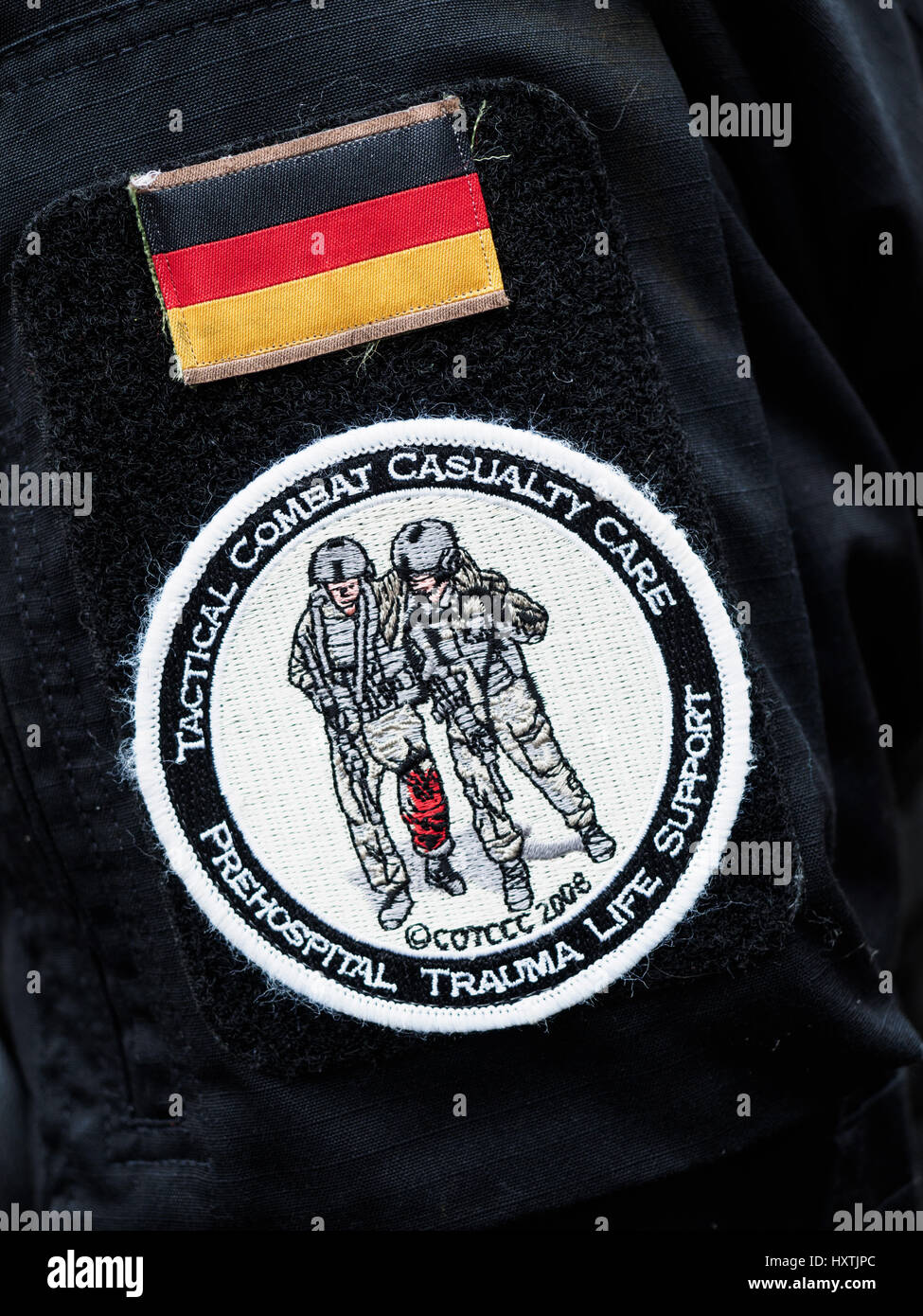 Geiselwind, Germany. 03rd Mar, 2017. The logo of the Tactical Combat Casualty Care (TCCC) course and a German flag on a jacket during a training exercise in Geiselwind, Germany, 03 March 2017. Emergency responders are often the first on the scene in the wake of a terror attack or a killing spree. A special training course aims to prepare them for the worst. Photo: Nicolas Armer/dpa/Alamy Live News Stock Photo