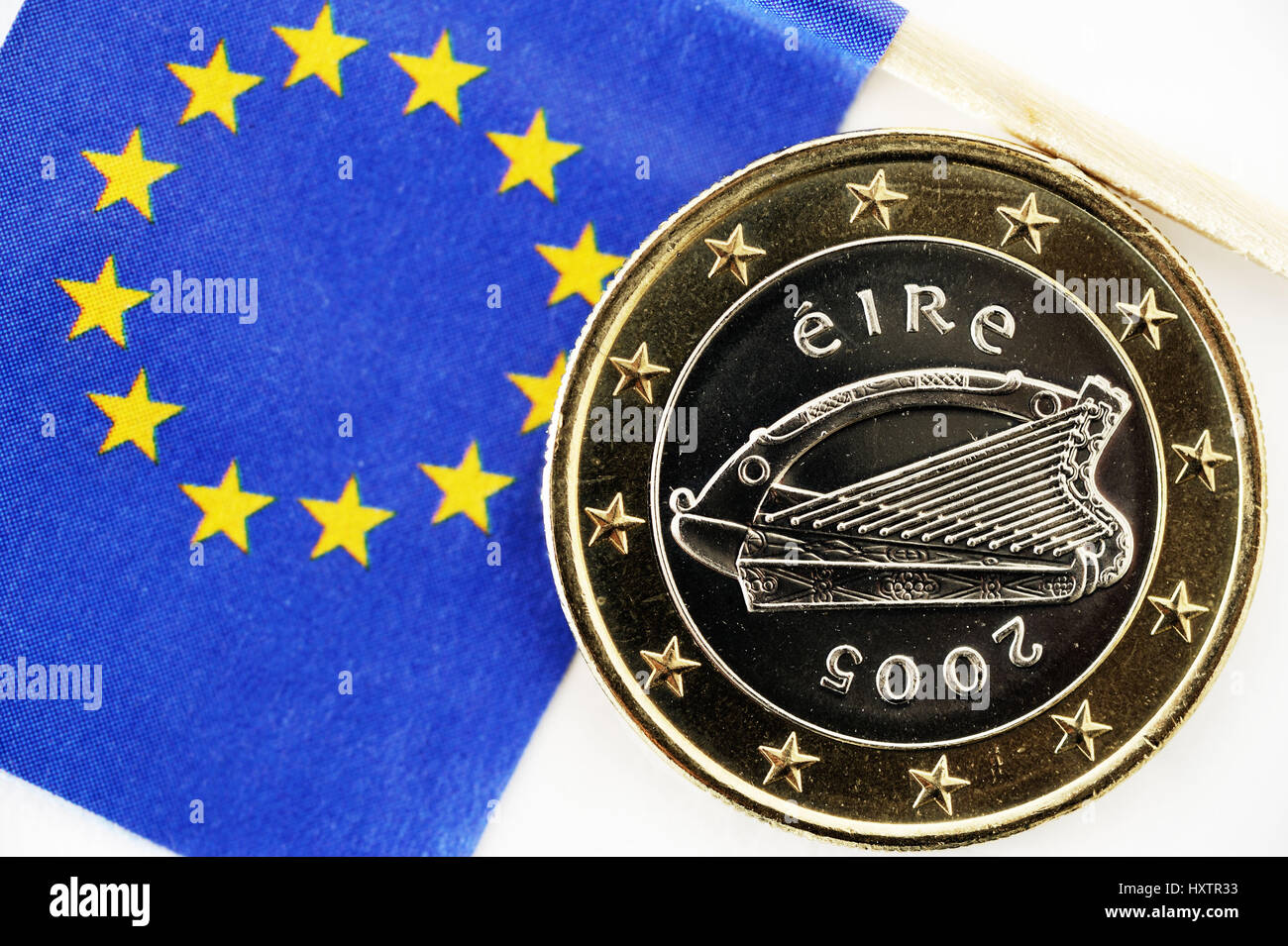 Irish euro-coin one and EU flag, state crisis Ireland, Irische Ein-Euro-Münze und EU-Fahne, Staatskrise Irland Stock Photo