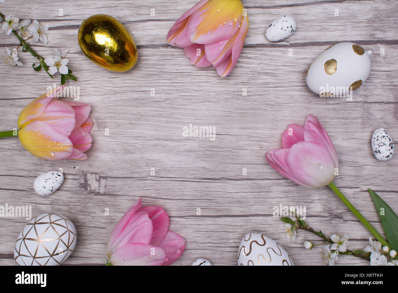 Easter eggs and tulips over wooden background Stock Photo - Alamy