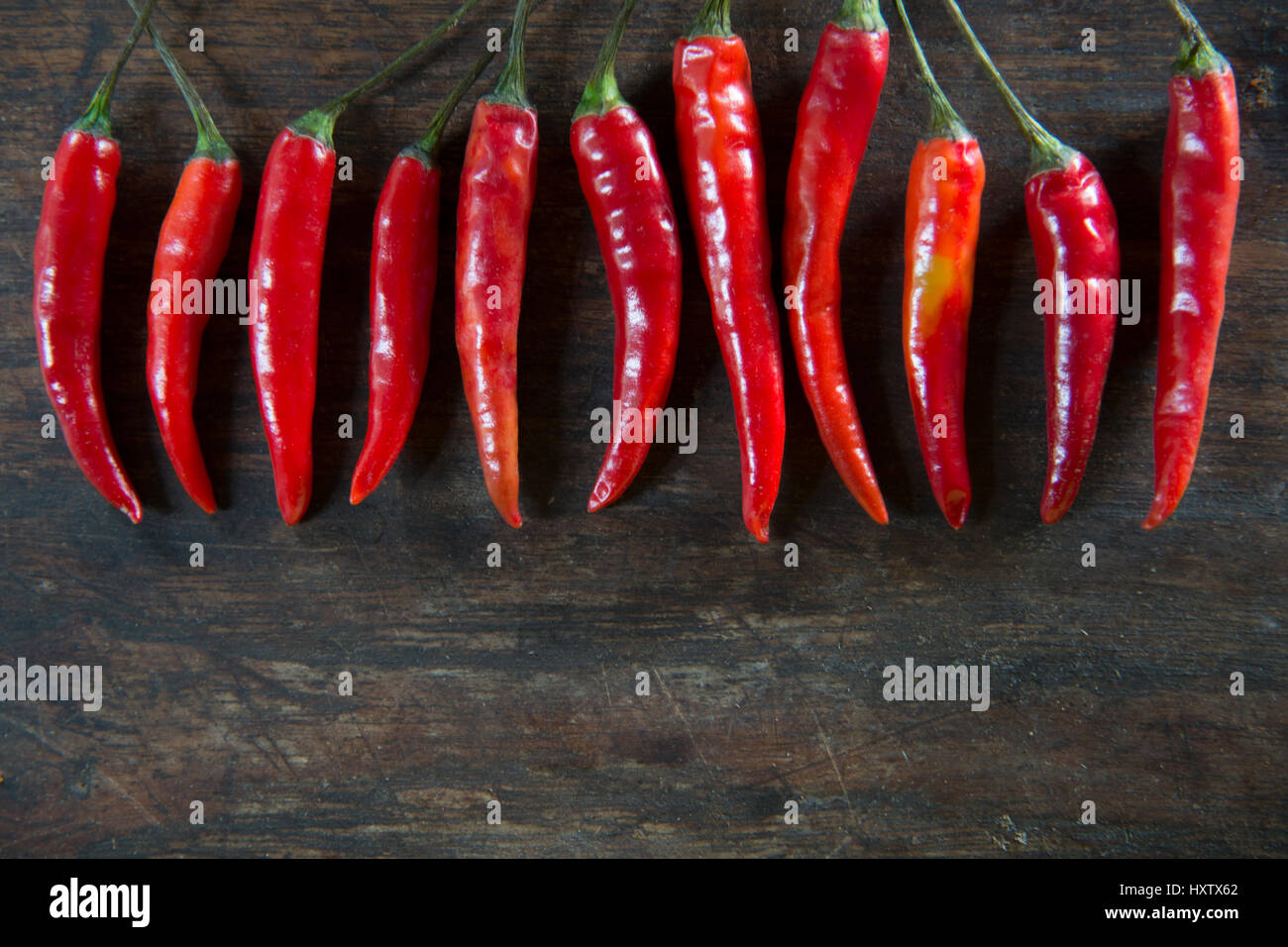 Red hot chilli pepper on wooden tabel background Stock Photo - Alamy