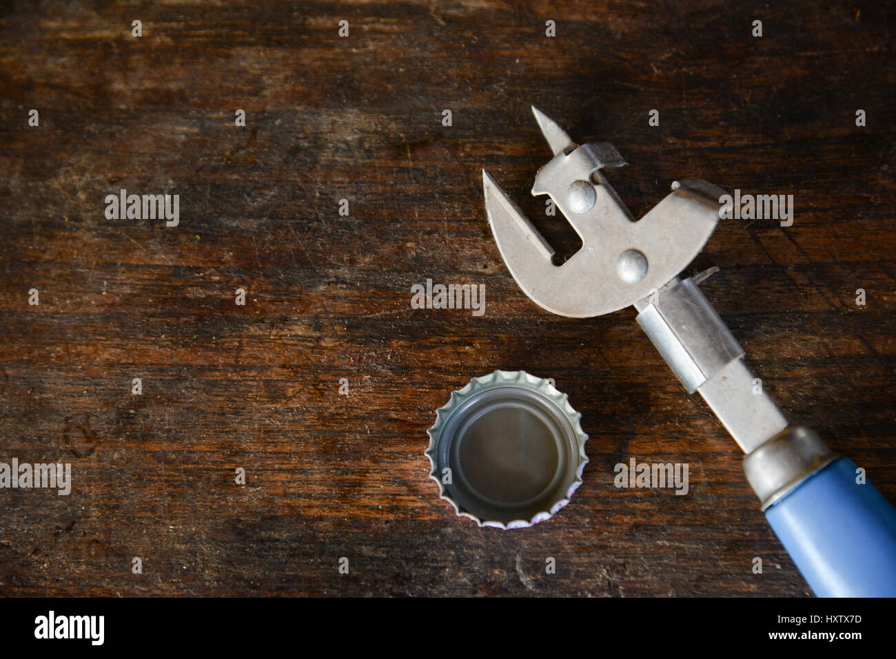 bottle opener with Bottle Cap on wooden table background Stock Photo