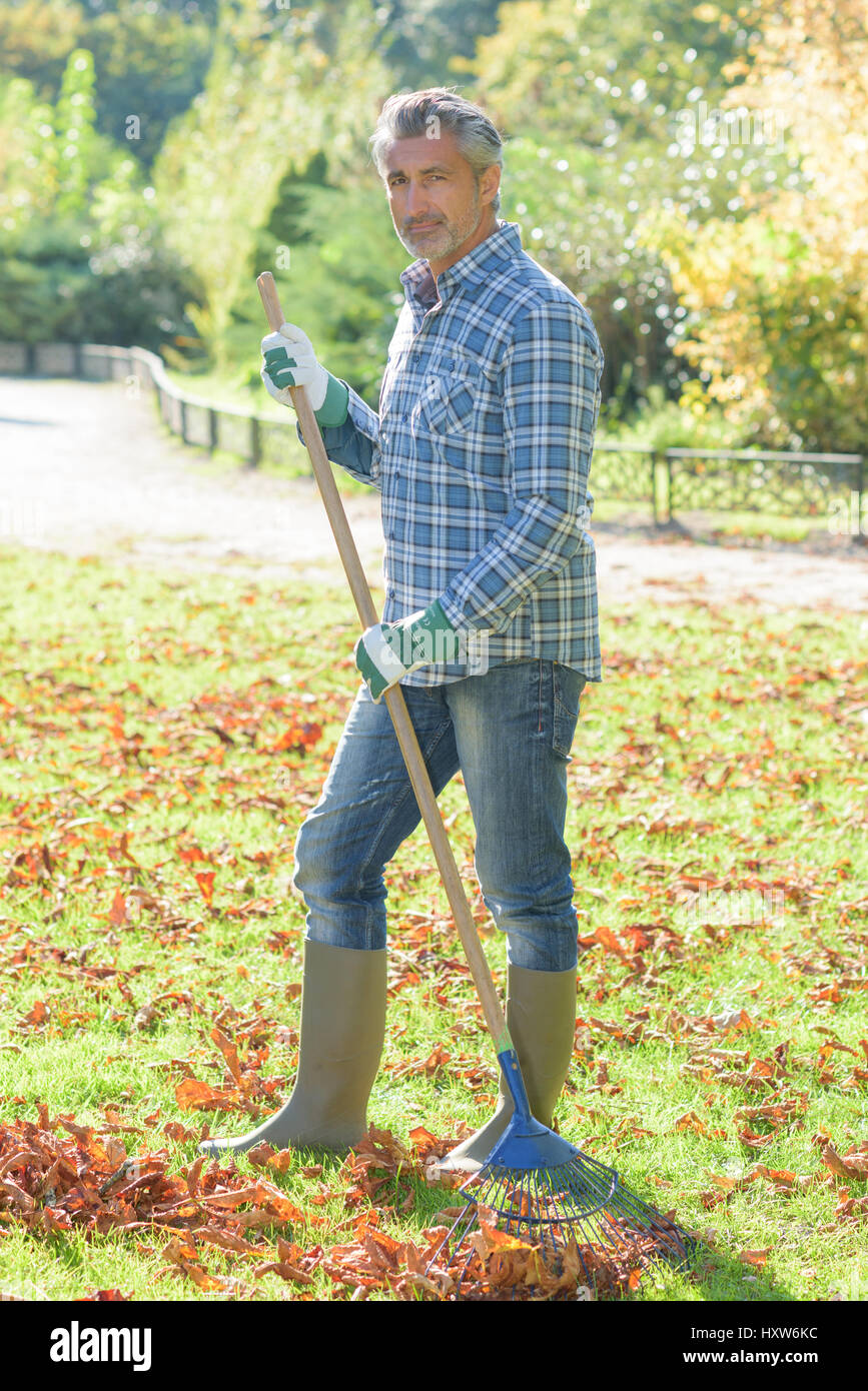 gadener holding a rake Stock Photo - Alamy