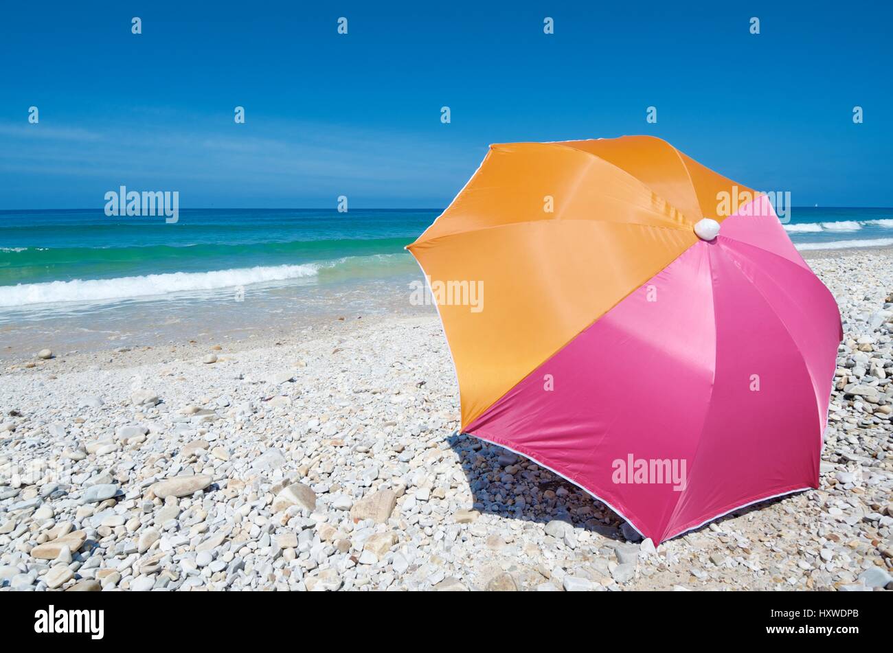 Umbrella on the beach of San Antolin, Cantabrian Sea,  Llanes, Asturias, Spain Stock Photo