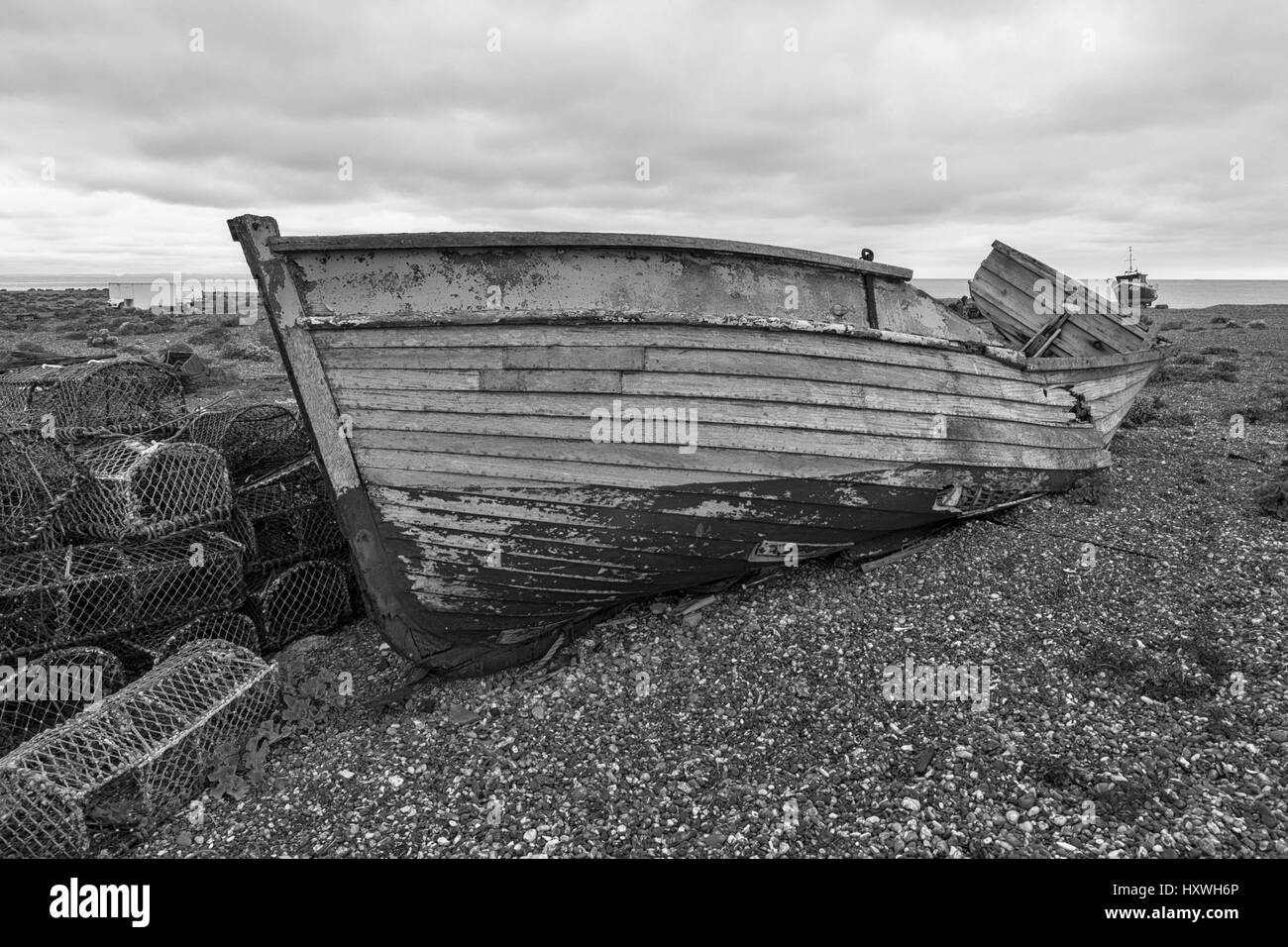 The wreck of an old wooden fishing boat on the shingle beach at ...