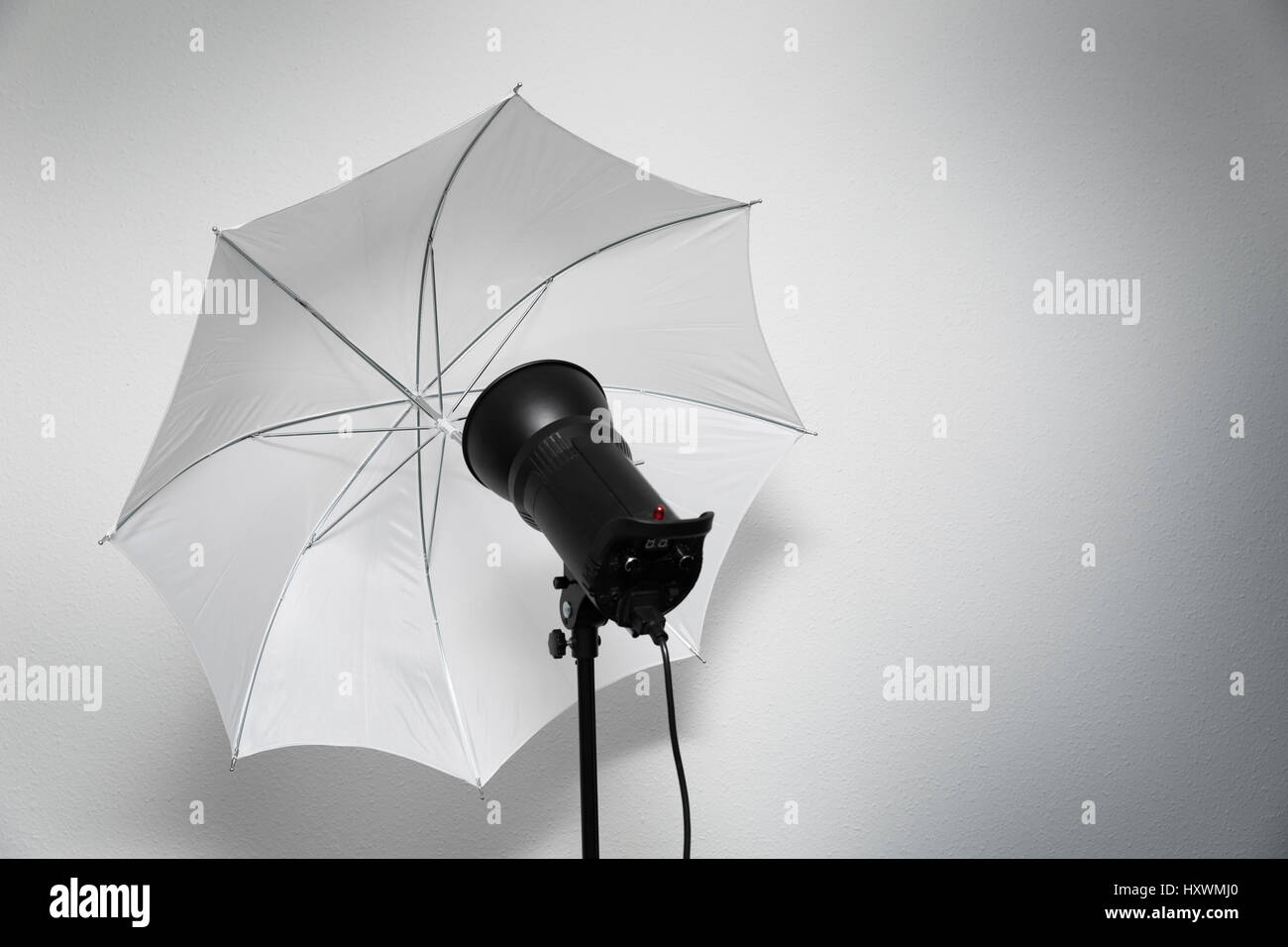 photo studio lightning - strobe flash with white umbrella Stock Photo