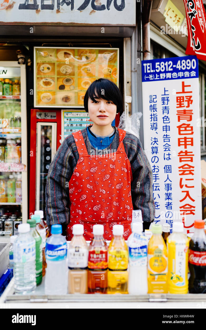 Japanese woman selling beverages on street food stall Stock Photo