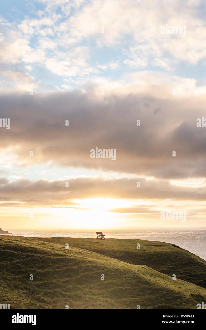 A bench in the middle of the beautiful landscape in Gásadalur, which is a village on Vágar in the Faroe Islands. Stock Photo