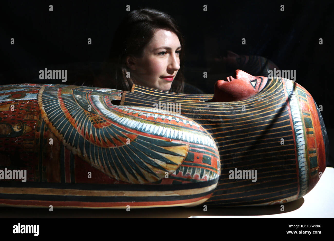 Senior curator Dr Margaret Maitland takes a closer look at the mummy-case of Egyptian priest Nehemsumut which is on display in The Tomb: Ancient Egyptian Burial exhibition at the National Museum of Scotland in Edinburgh. Stock Photo