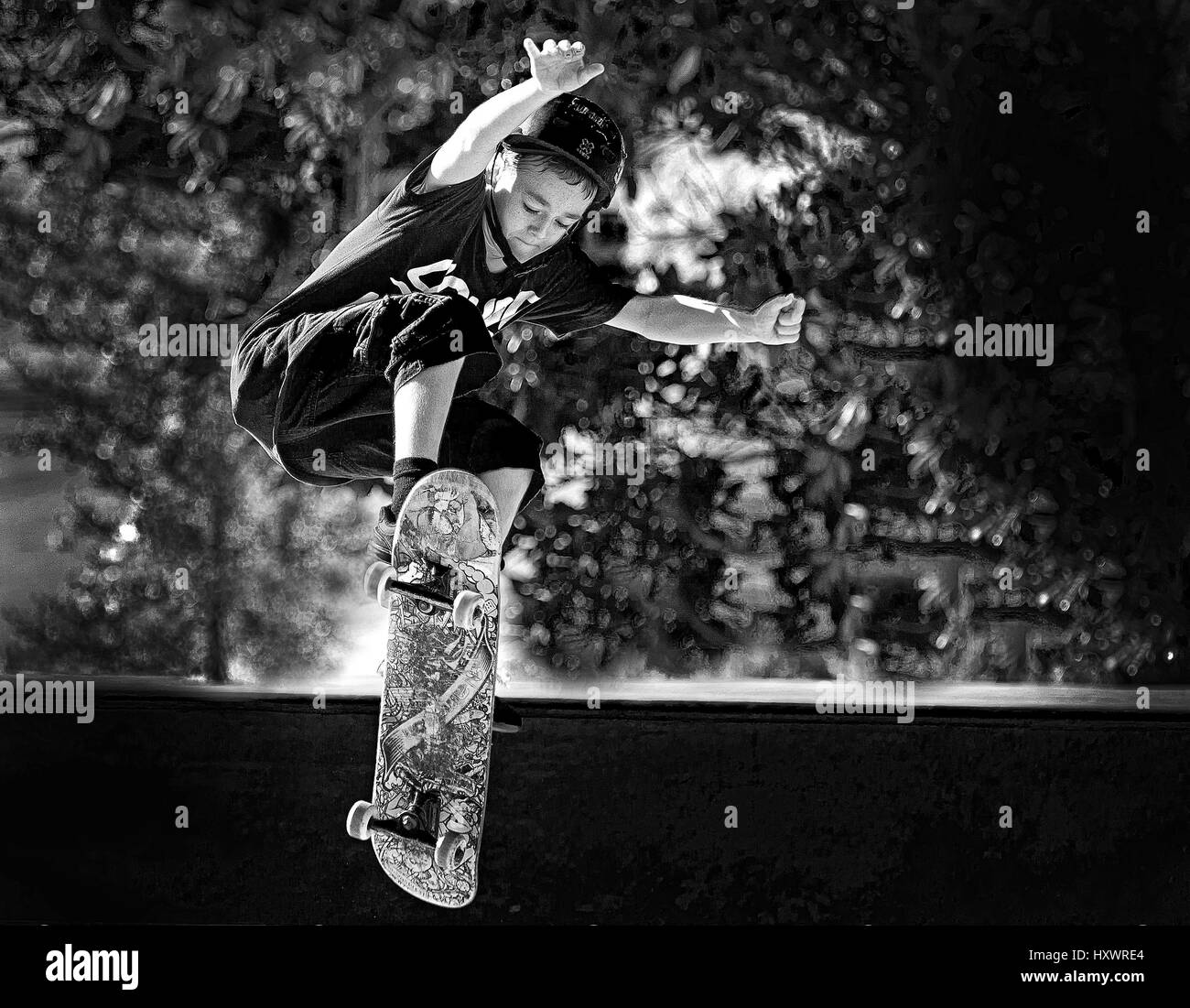 young boy skate boarding  in black & white Stock Photo