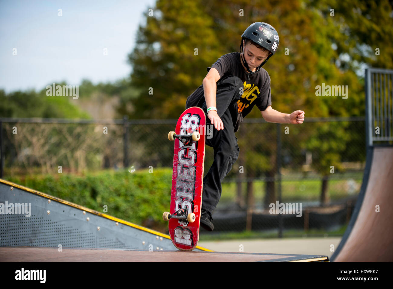 young boy skate boarding jumping Stock Photo