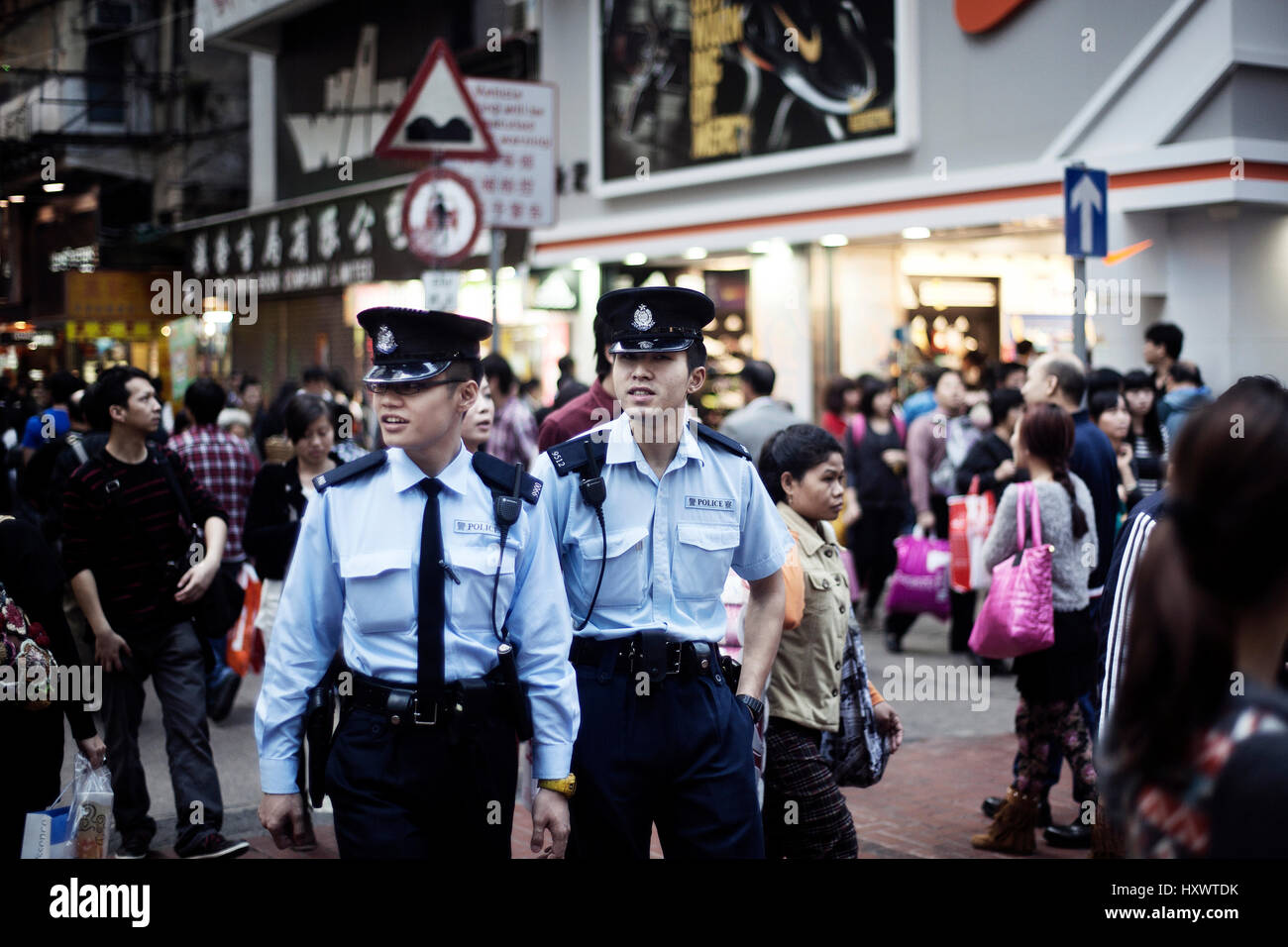 Two police men on duty on a street in Hong Kong, China. Stock Photo