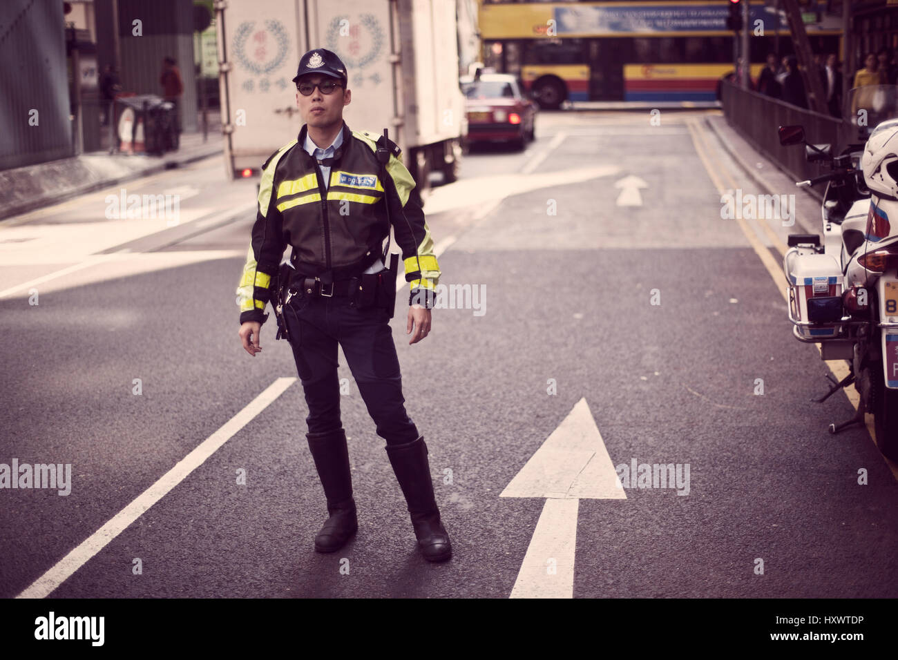 A police man on duty on a street in Hong Kong, China. Stock Photo