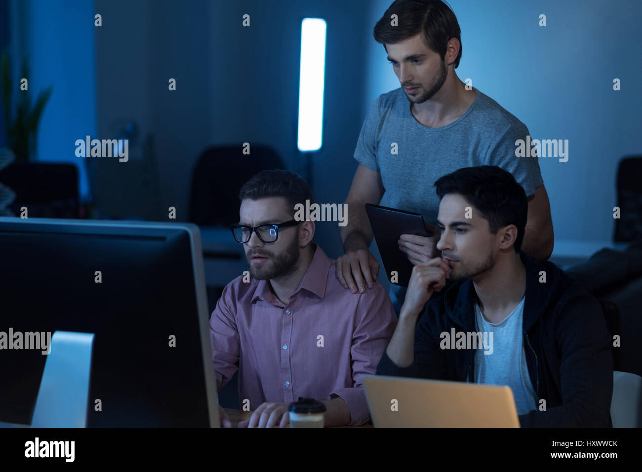 Intelligent handsome programmer working on the computer Stock Photo - Alamy
