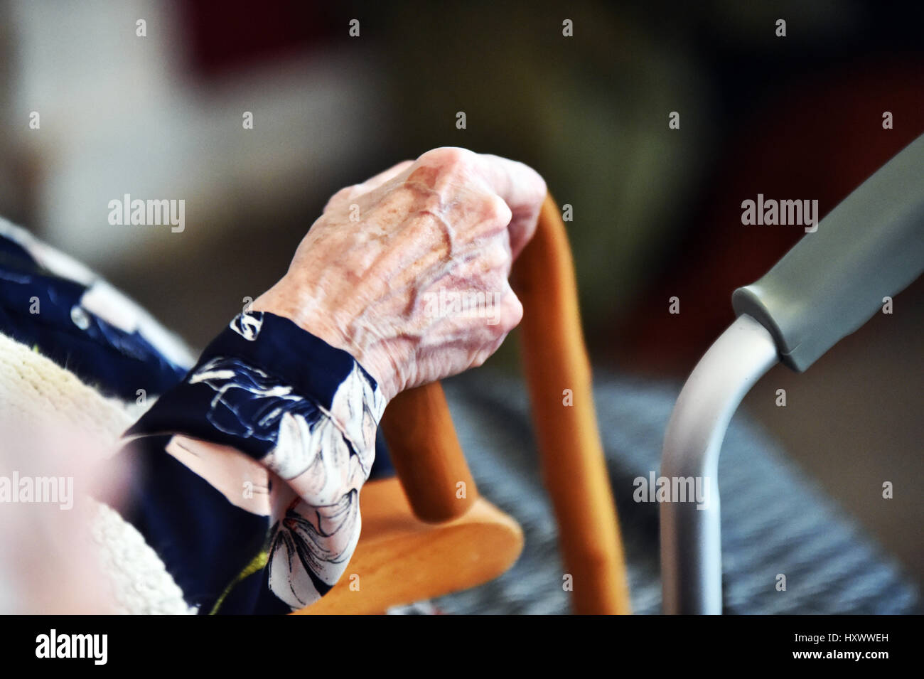 Close up of elderly ladies hand holding her walking stick in a care home, Yorkshire UK Stock Photo