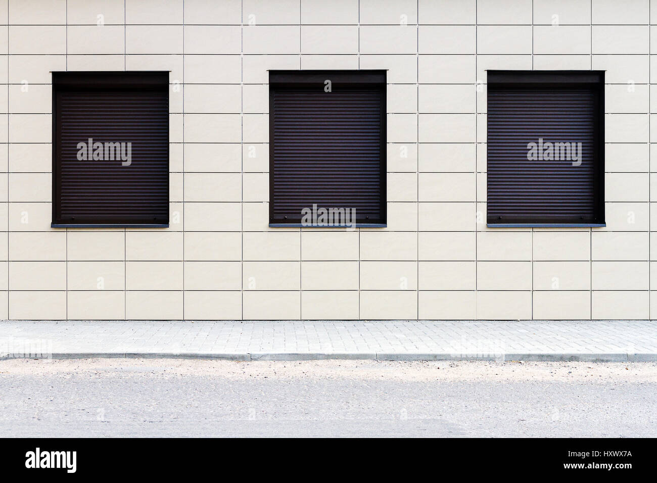 Modern tiled street wall with three windows Stock Photo - Alamy