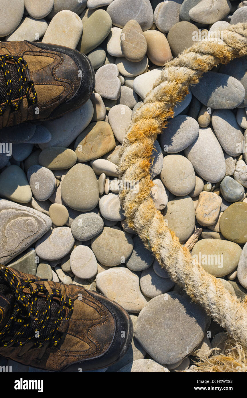 High Rope Pebble Bridge old worn battered marine rope on the pebble beach on a Sunny summer day ...