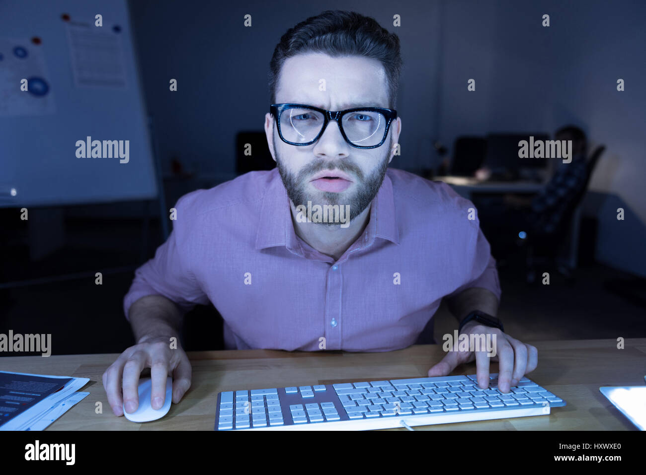 Serious hard working programmer looking at the screen Stock Photo