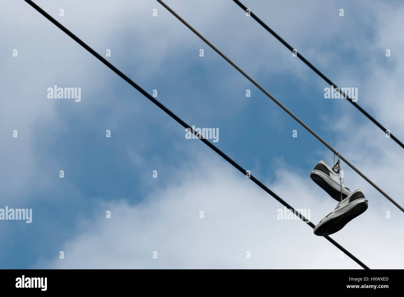 Sneakers hanging from wire Stock Photo Alamy
