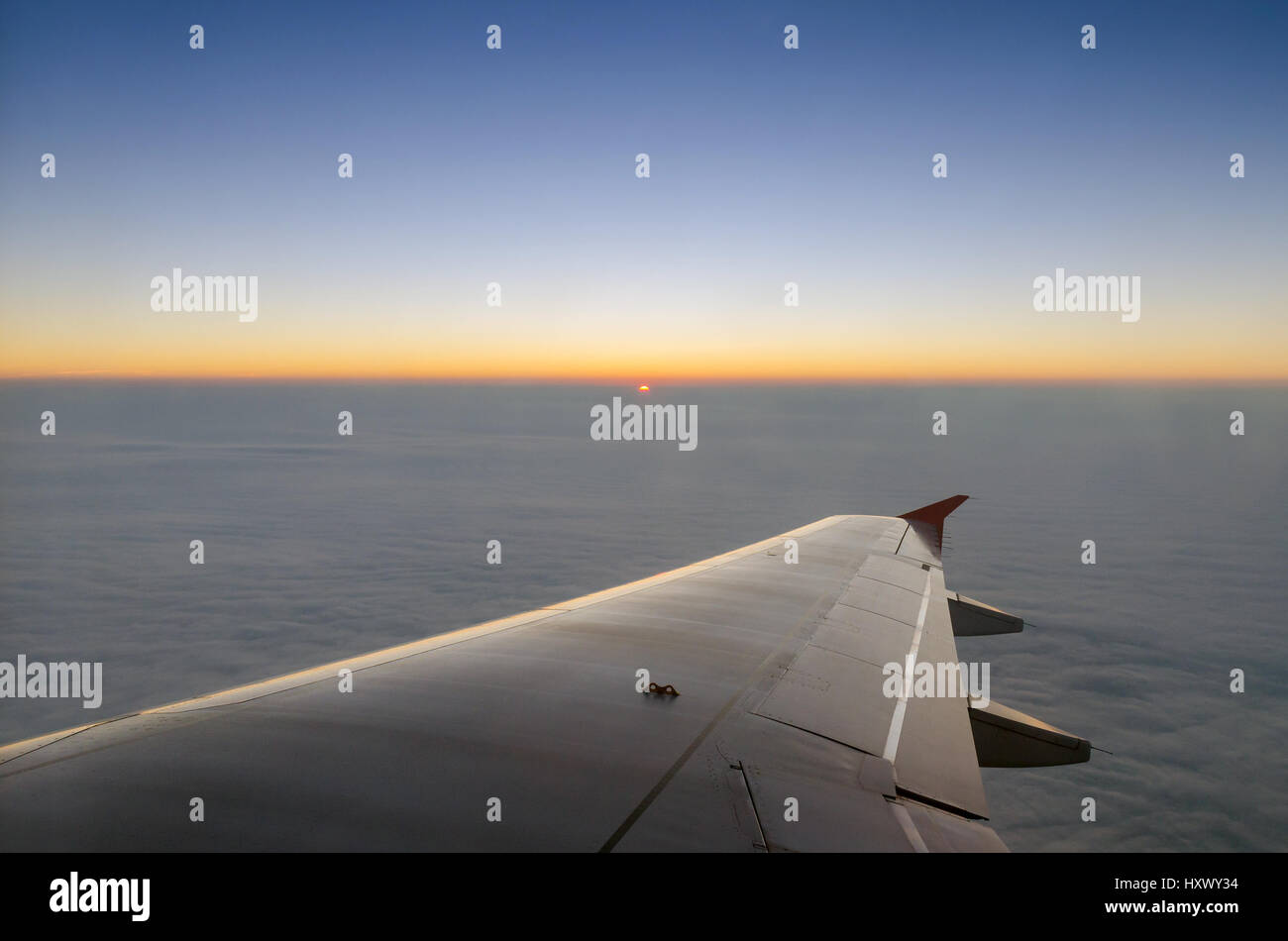 Airplane wing and sunset sky Stock Photo - Alamy