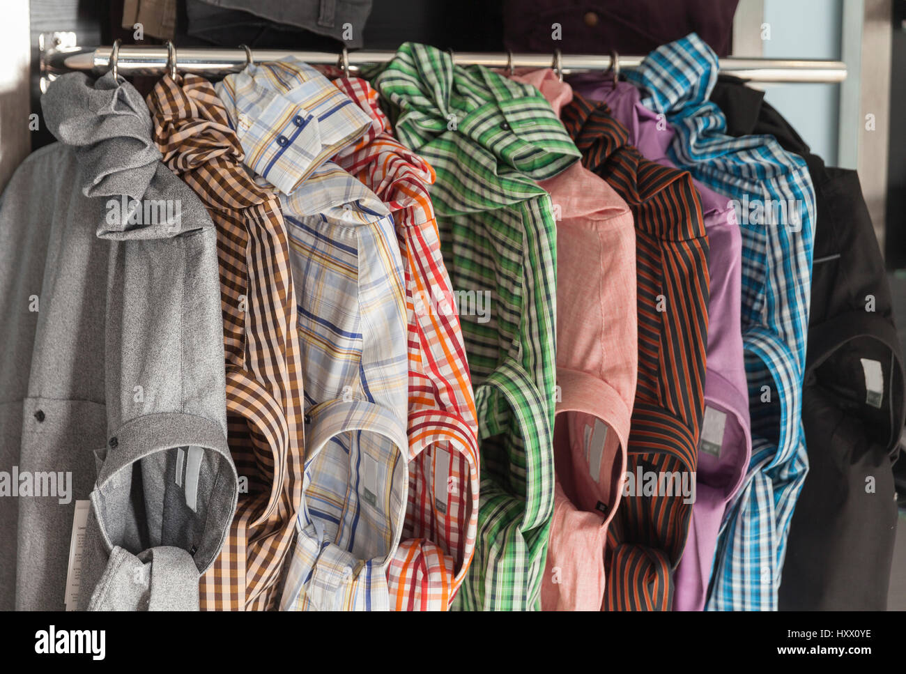several models of men 's shirts on a shelf Stock Photo